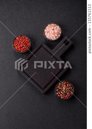 Wood, a wooden empty cutting board on a dark kitchen table. Wooden cutting board Wood, a wooden empty cutting board on a dark kitchen table. Wooden cutting board 135761513