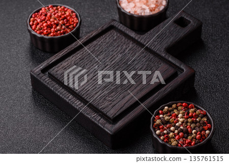 Wood, a wooden empty cutting board on a dark kitchen table. Wooden cutting board Wood, a wooden empty cutting board on a dark kitchen table. Wooden cutting board 135761515