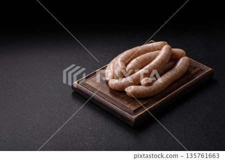 Raw pork or chicken meat sausages for grilling, a spicy picnic food. Raw sausages 135761663