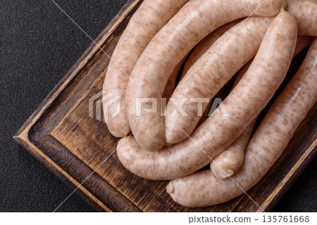 Raw pork or chicken meat sausages for grilling, a spicy picnic food. Raw sausages Raw pork or chicken meat sausages for grilling, a spicy picnic food. Raw sausages 135761668