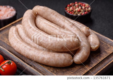 Raw pork or chicken meat sausages for grilling, a spicy picnic food. Raw sausages Raw pork or chicken meat sausages for grilling, a spicy picnic food. Raw sausages 135761671