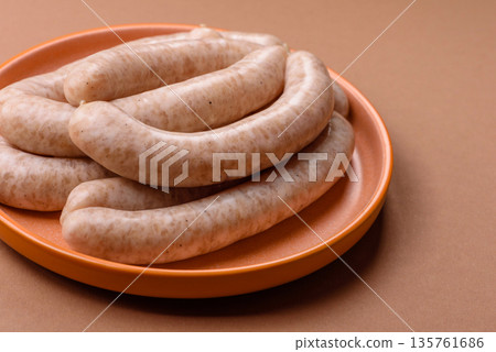 Raw pork or chicken meat sausages for grilling, a spicy picnic food. Raw sausages Raw pork or chicken meat sausages for grilling, a spicy picnic food. Raw sausages 135761686