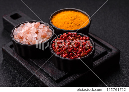 Indian spices, pepper, salt, turmeric, ingredients for cooking. Spices pepper, salt, and turmeric Indian spices, pepper, salt, turmeric, ingredients for cooking. Spices pepper, salt, and turmeric 135761732