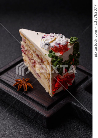 A slice of sweet layered cake with a Christmas ornament and fruit flavor. A slice of cake A slice of sweet layered cake with a Christmas ornament and fruit flavor. A slice of cake 135762077