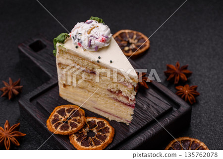 A slice of sweet layered cake with a Christmas ornament and fruit flavor. A slice of cake A slice of sweet layered cake with a Christmas ornament and fruit flavor. A slice of cake 135762078