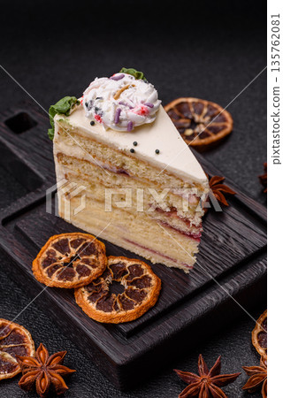 A slice of sweet layered cake with a Christmas ornament and fruit flavor. A slice of cake A slice of sweet layered cake with a Christmas ornament and fruit flavor. A slice of cake 135762081