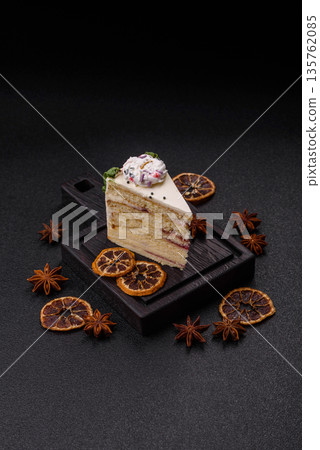 A slice of sweet layered cake with a Christmas ornament and fruit flavor. A slice of cake A slice of sweet layered cake with a Christmas ornament and fruit flavor. A slice of cake 135762085