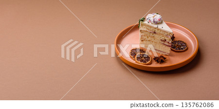 A slice of sweet layered cake with a Christmas ornament and fruit flavor. A slice of cake A slice of sweet layered cake with a Christmas ornament and fruit flavor. A slice of cake 135762086