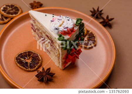 A slice of sweet layered cake with a Christmas ornament and fruit flavor. A slice of cake A slice of sweet layered cake with a Christmas ornament and fruit flavor. A slice of cake 135762093