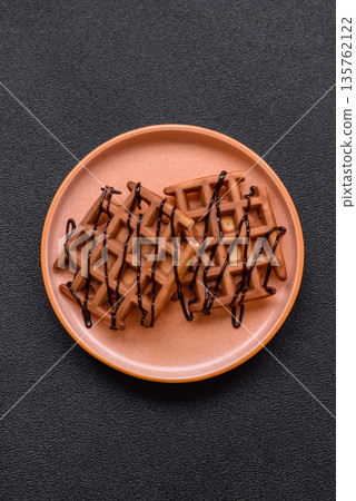 Belgian waffles, a healthy sweet breakfast dessert, food background. Belgian waffles 135762122