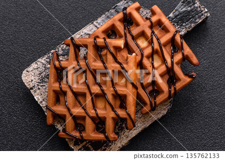Belgian waffles, a healthy sweet breakfast dessert, food background. Belgian waffles Belgian waffles, a healthy sweet breakfast dessert, food background. Belgian waffles 135762133