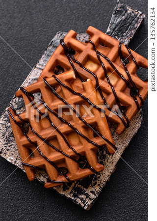 Belgian waffles, a healthy sweet breakfast dessert, food background. Belgian waffles 135762134