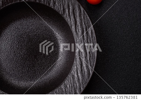 An empty round ceramic plate on a table, kitchenware. An empty plate An empty round ceramic plate on a table, kitchenware. An empty plate 135762381