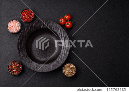 An empty round ceramic plate on a table, kitchenware. An empty plate An empty round ceramic plate on a table, kitchenware. An empty plate 135762385