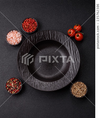 An empty round ceramic plate on a table, kitchenware. An empty plate An empty round ceramic plate on a table, kitchenware. An empty plate 135762386