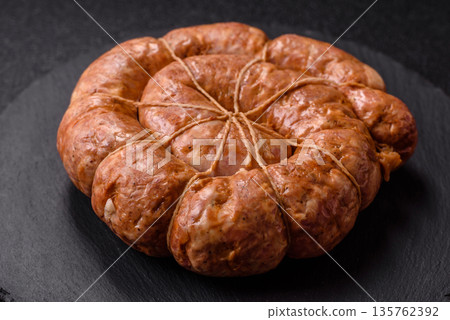 Grilled sausage in the shape of a spiral or snail, from chicken or pork. Spiral or snail sausage Grilled sausage in the shape of a spiral or snail, from chicken or pork. Spiral or snail sausage 135762392