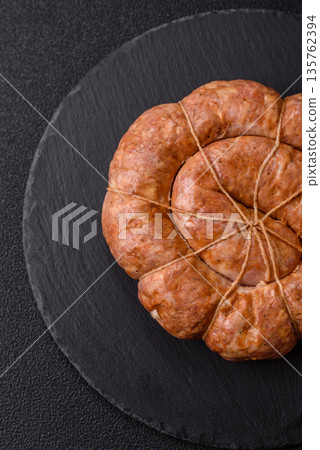 Grilled sausage in the shape of a spiral or snail, from chicken or pork. Spiral or snail sausage 135762394