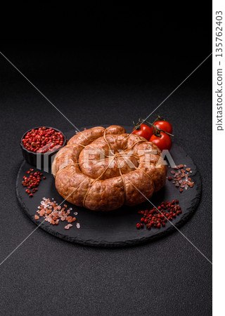 Grilled sausage in the shape of a spiral or snail, from chicken or pork. Spiral or snail sausage 135762403