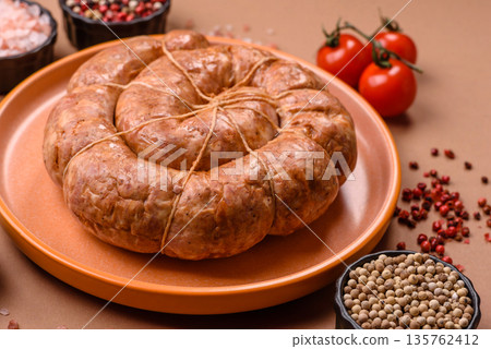 Grilled sausage in the shape of a spiral or snail, from chicken or pork. Spiral or snail sausage Grilled sausage in the shape of a spiral or snail, from chicken or pork. Spiral or snail sausage 135762412