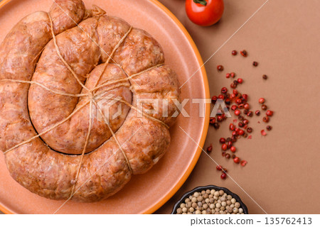 Grilled sausage in the shape of a spiral or snail, from chicken or pork. Spiral or snail sausage Grilled sausage in the shape of a spiral or snail, from chicken or pork. Spiral or snail sausage 135762413