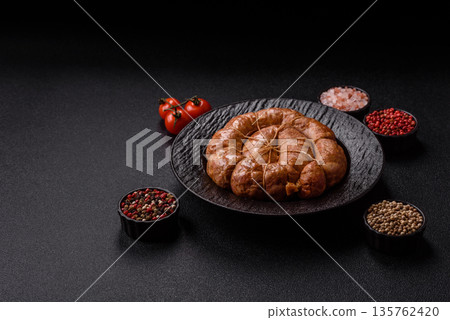 Grilled sausage in the shape of a spiral or snail, from chicken or pork. Spiral or snail sausage Grilled sausage in the shape of a spiral or snail, from chicken or pork. Spiral or snail sausage 135762420
