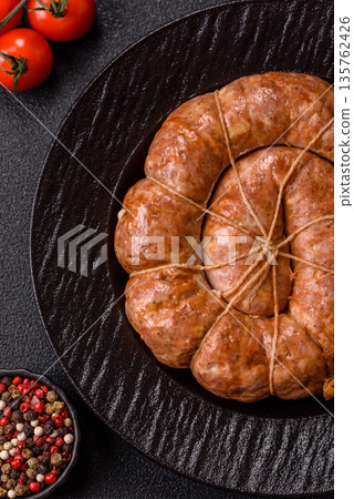 Grilled sausage in the shape of a spiral or snail, from chicken or pork. Spiral or snail sausage Grilled sausage in the shape of a spiral or snail, from chicken or pork. Spiral or snail sausage 135762426