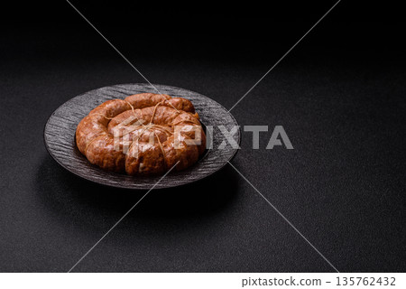 Grilled sausage in the shape of a spiral or snail, from chicken or pork. Spiral or snail sausage Grilled sausage in the shape of a spiral or snail, from chicken or pork. Spiral or snail sausage 135762432