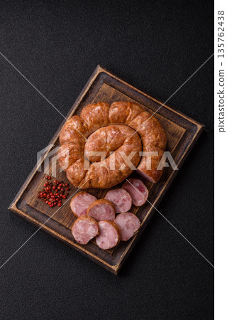 Grilled sausage in the shape of a spiral or snail, from chicken or pork. Spiral or snail sausage 135762438