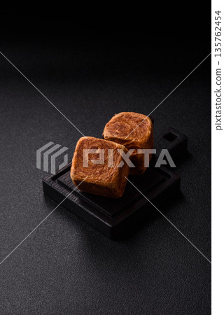 A French cube croissant with chocolate filling, a sweet breakfast pastry. Cube croissant A French cube croissant with chocolate filling, a sweet breakfast pastry. Cube croissant 135762454
