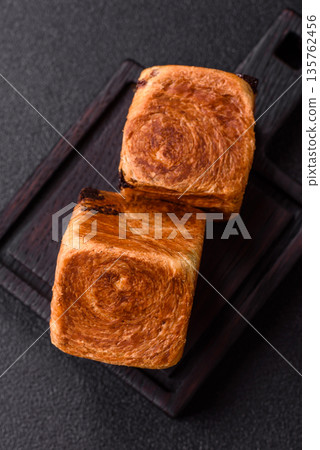 A French cube croissant with chocolate filling, a sweet breakfast pastry. Cube croissant A French cube croissant with chocolate filling, a sweet breakfast pastry. Cube croissant 135762456