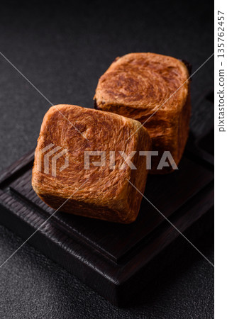 A French cube croissant with chocolate filling, a sweet breakfast pastry. Cube croissant A French cube croissant with chocolate filling, a sweet breakfast pastry. Cube croissant 135762457