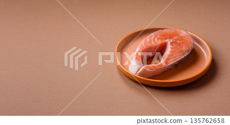 Fish, raw salmon steak, fresh seafood for grilling with salt, spices, and herbs. Raw salmon steak Fish, raw salmon steak, fresh seafood for grilling with salt, spices, and herbs. Raw salmon steak 135762658