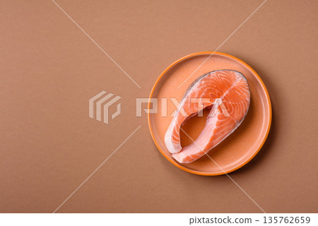Fish, raw salmon steak, fresh seafood for grilling with salt, spices, and herbs. Raw salmon steak 135762659