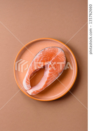 Fish, raw salmon steak, fresh seafood for grilling with salt, spices, and herbs. Raw salmon steak 135762660