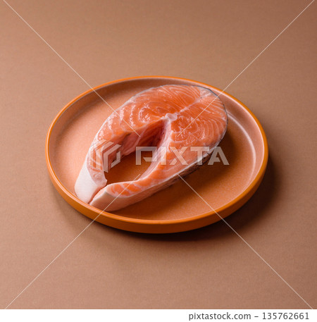 Fish, raw salmon steak, fresh seafood for grilling with salt, spices, and herbs. Raw salmon steak Fish, raw salmon steak, fresh seafood for grilling with salt, spices, and herbs. Raw salmon steak 135762661