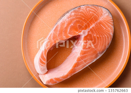 Fish, raw salmon steak, fresh seafood for grilling with salt, spices, and herbs. Raw salmon steak 135762663