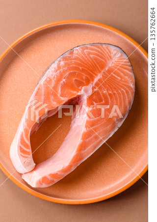 Fish, raw salmon steak, fresh seafood for grilling with salt, spices, and herbs. Raw salmon steak 135762664