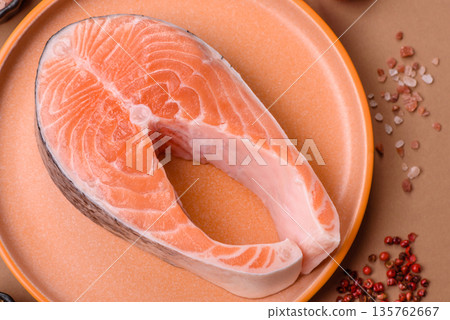 Fish, raw salmon steak, fresh seafood for grilling with salt, spices, and herbs. Raw salmon steak 135762667