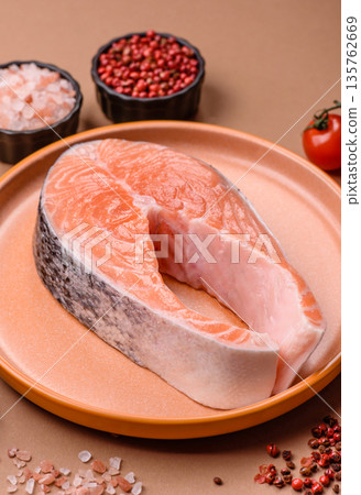 Fish, raw salmon steak, fresh seafood for grilling with salt, spices, and herbs. Raw salmon steak Fish, raw salmon steak, fresh seafood for grilling with salt, spices, and herbs. Raw salmon steak 135762669