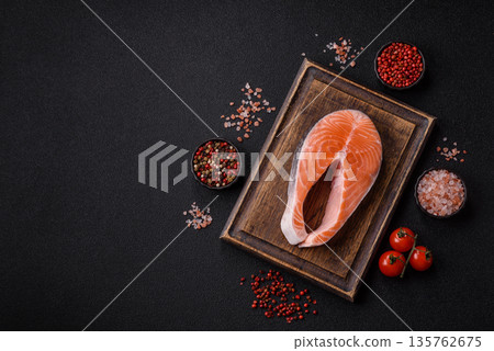 Fish, raw salmon steak, fresh seafood for grilling with salt, spices, and herbs. Raw salmon steak Fish, raw salmon steak, fresh seafood for grilling with salt, spices, and herbs. Raw salmon steak 135762675