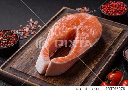 Fish, raw salmon steak, fresh seafood for grilling with salt, spices, and herbs. Raw salmon steak Fish, raw salmon steak, fresh seafood for grilling with salt, spices, and herbs. Raw salmon steak 135762678