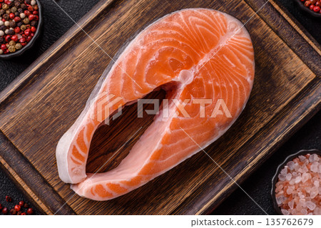 Fish, raw salmon steak, fresh seafood for grilling with salt, spices, and herbs. Raw salmon steak Fish, raw salmon steak, fresh seafood for grilling with salt, spices, and herbs. Raw salmon steak 135762679