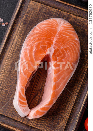 Fish, raw salmon steak, fresh seafood for grilling with salt, spices, and herbs. Raw salmon steak Fish, raw salmon steak, fresh seafood for grilling with salt, spices, and herbs. Raw salmon steak 135762680