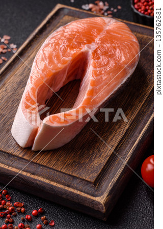 Fish, raw salmon steak, fresh seafood for grilling with salt, spices, and herbs. Raw salmon steak 135762681