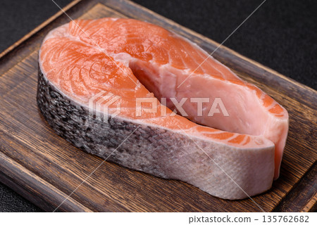 Fish, raw salmon steak, fresh seafood for grilling with salt, spices, and herbs. Raw salmon steak Fish, raw salmon steak, fresh seafood for grilling with salt, spices, and herbs. Raw salmon steak 135762682