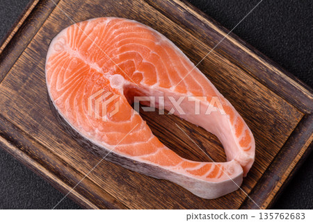 Fish, raw salmon steak, fresh seafood for grilling with salt, spices, and herbs. Raw salmon steak 135762683