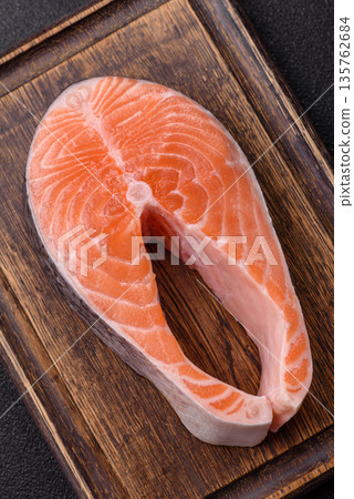 Fish, raw salmon steak, fresh seafood for grilling with salt, spices, and herbs. Raw salmon steak 135762684