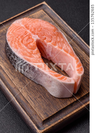 Fish, raw salmon steak, fresh seafood for grilling with salt, spices, and herbs. Raw salmon steak Fish, raw salmon steak, fresh seafood for grilling with salt, spices, and herbs. Raw salmon steak 135762685