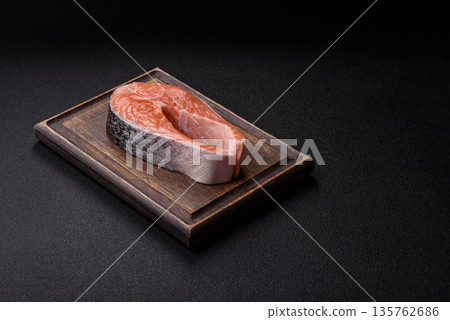 Fish, raw salmon steak, fresh seafood for grilling with salt, spices, and herbs. Raw salmon steak 135762686
