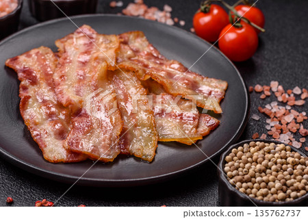 Fried smoked bacon slices, ham, jamon, or prosciutto strips for cooking. Fried bacon 135762737